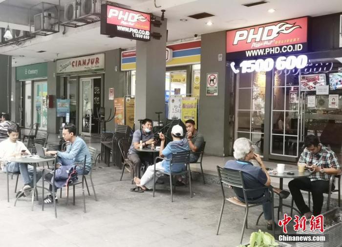 资料图：图为1月25日，雅加达市中心一居民小区门口，民众在户外闲聊。<a target='_blank' href='http://www.chinanews.com/'><p  align=