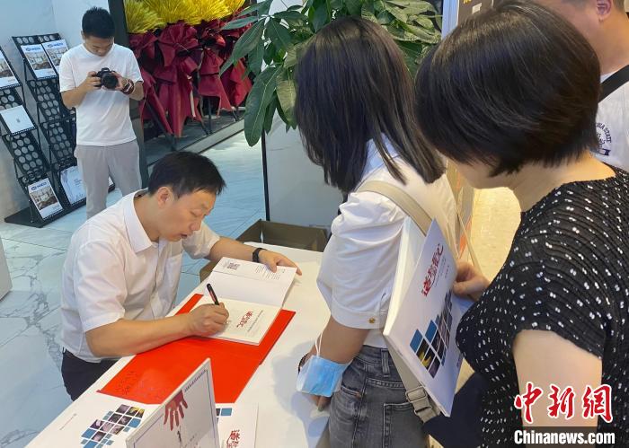 图为纪实摄影作品《道听图说》公益签售会现场。　殷缘摄