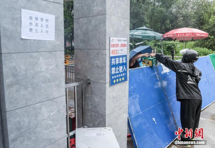 7月29日，北京新增确诊病例所在的居民小区已封闭，外卖人员向小区内递送居民购买的生活用品。 <a target='_blank' href='http://www.chinanews.com/'><p  align=
